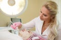 Cosmetologist applying facial peeling mask