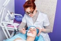 Cosmetologist applying mask on the face Royalty Free Stock Photo