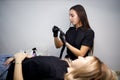 Cosmetologist checking equipment before making lips microblading tattoo procedure