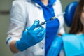 Cosmetologist doctor in blue medical gloves holding syringe with injections before treatment, closeup. Beautician on mesotherapy Royalty Free Stock Photo