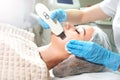 Cosmetologist doing ultrasound face peeling