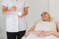 Cosmetologist hands, preparing cleansing mask.