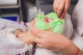 cosmetologist with the help of a special make-up brush makes a therapeutic spa mask from green algae against aging of a Royalty Free Stock Photo