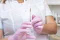 cosmetologist holds a syringe for injection.