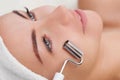 The cosmetologist makes the apparatus a procedure of Microcurrent therapy of a beautiful, young woman in a beauty salon. Royalty Free Stock Photo