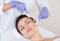 The cosmetologist makes the apparatus a procedure of Microcurrent therapy of a beautiful, young woman in a beauty salon. Royalty Free Stock Photo