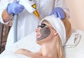 The cosmetologist makes carbon face peeling procedure in a beauty salon. Hardware cosmetology treatment in the beauty salon Royalty Free Stock Photo