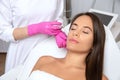 Cosmetologist makes lipolytic injections to burn fat on the chin, cheeks and neck of a woman against double chin. Female aesthetic