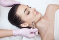 The cosmetologist makes the procedure Microdermabrasion of the face skin of a beautiful woman in a beauty salon.Cosmetology and Royalty Free Stock Photo