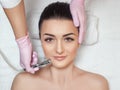 The cosmetologist makes the procedure Microdermabrasion of the face skin of a beautiful woman in a beauty salon.Cosmetology and Royalty Free Stock Photo