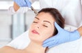 The cosmetologist makes the procedure Microdermabrasion of the face skin of a beautiful woman in a beauty salon.Cosmetology and Royalty Free Stock Photo