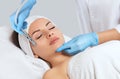 The cosmetologist makes the procedure Microdermabrasion of the face skin of a beautiful woman in a beauty salon.Cosmetology and Royalty Free Stock Photo