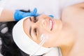 The cosmetologist makes the procedure for peeling of the face skin of a beautiful woman in a beauty salon, cosmetology Royalty Free Stock Photo