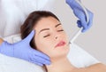 The cosmetologist makes the procedure treatment of Couperose and face cleaning of the skin of a beautiful, young woman in a beauty Royalty Free Stock Photo