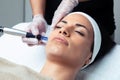 Cosmetologist making mesotherapy injection with dermapen on face for rejuvenation on the spa center