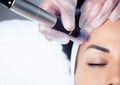 Cosmetologist making mesotherapy injection with dermapen on face for rejuvenation on the spa center