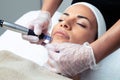 Cosmetologist making mesotherapy injection with dermapen on face for rejuvenation on the spa center