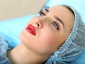 Cosmetologist making permanent makeup on woman's face Royalty Free Stock Photo