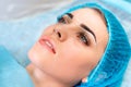 Cosmetologist making permanent makeup on woman`s face Royalty Free Stock Photo