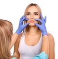 Cosmetologist making permanent makeup on woman`s lips Royalty Free Stock Photo