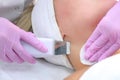 Cosmetologist makes ultrasonic face cleaning to woman in clinic, closeup view. Royalty Free Stock Photo