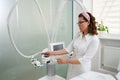 Cosmetologist operating modern cosmetology equipment for lpg procedure in beauty clinic. Bodycare concept