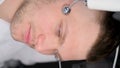 The cosmetologist performs the Iontophoresis procedure. Vertical video