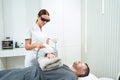 Cosmetologist performs a photorejuvenation procedure on the patients hands