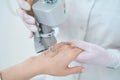 Cosmetologist performs a procedure for removing neoplasms with a laser