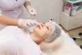 Cosmetologist prepares the client`s lips for the augmentation procedure Royalty Free Stock Photo