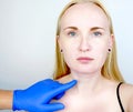 A cosmetologist prepares the patient for surgery: contour plastics of the neck, mesotherapy or botulinum therapy. Wrinkles and