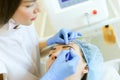 Cosmetologist shaping eyebrows before microblading.