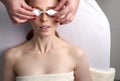 Cosmetologist wearing eyeglasses on female face before hotodynamic face mask therapy