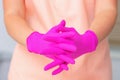 Cosmetologist wearing latex gloves during preparation before beauty procedures