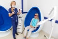 Cosmetologist whitens the patient`s teeth Royalty Free Stock Photo