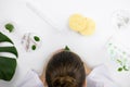 Cosmetologists head above cosmetic lab table with cosmetic sponges, glass flasks