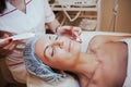 Cosmetology doctor makes woman treatments facial massage