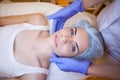 Cosmetology doctor makes woman treatments facial massage