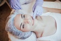 Cosmetology doctor makes woman treatments facial massage