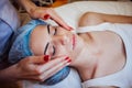 Cosmetology doctor makes woman treatments facial massage