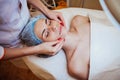 Cosmetology doctor makes woman treatments facial massage