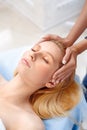 Cosmetology Service. Young woman at beauty clinic lying relaxed while doctor touching head preparation for procedure