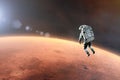 Cosmonaut floating  in outer space close to Mars planet. Elements of this image furnished by NASA Royalty Free Stock Photo