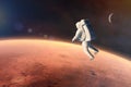 Cosmonaut floating in outer space close to Mars planet. Elements of this image furnished by NASA Royalty Free Stock Photo