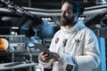 Cosmonaut using tablet in spacecraft, running suit diagnostics Royalty Free Stock Photo