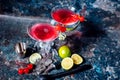 Cosmopolitan alcoholic cocktail drink at casino and bar served with lime, ice and cherries Royalty Free Stock Photo