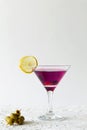 Cosmopolitan cocktail in the bar. martini glass of red cocktail with olives and lemon on white background. Royalty Free Stock Photo