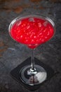 Cosmopolitan cocktail on a dark stone background, a mix of vodka, cranberry juice and lemon