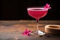 cosmopolitan cocktail embellished with a red cherry on a wooden table