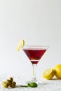 Cosmopolitan cocktail. Martini glass with cocktail and olives on white background. Royalty Free Stock Photo